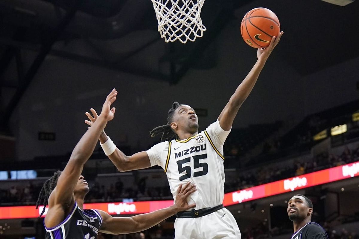 Dec 30, 2023; Columbia, Missouri, USA; Missouri Tigers guard Sean East II (55) scores as Central Arkansas Bears guard Carl Daughtery Jr. (11) defends during the first half  at Mizzou Arena.