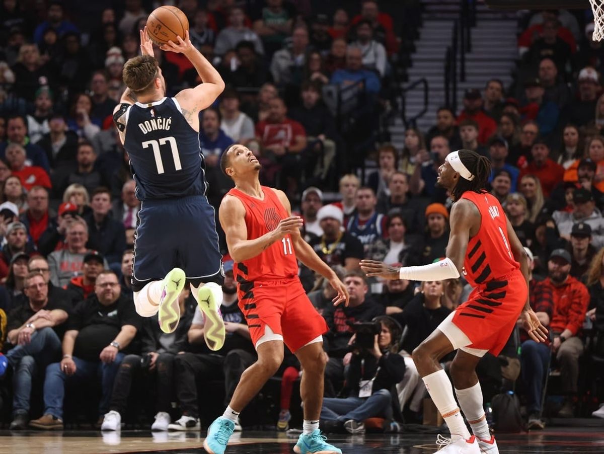 Dec 16, 2023; Portland, Oregon, USA; Dallas Mavericks guard Luka Doncic (77) shoots the ball after drawing a foul against Portland Trail Blazers guard Malcolm Brogdon (11)  in the first half at Moda Center.