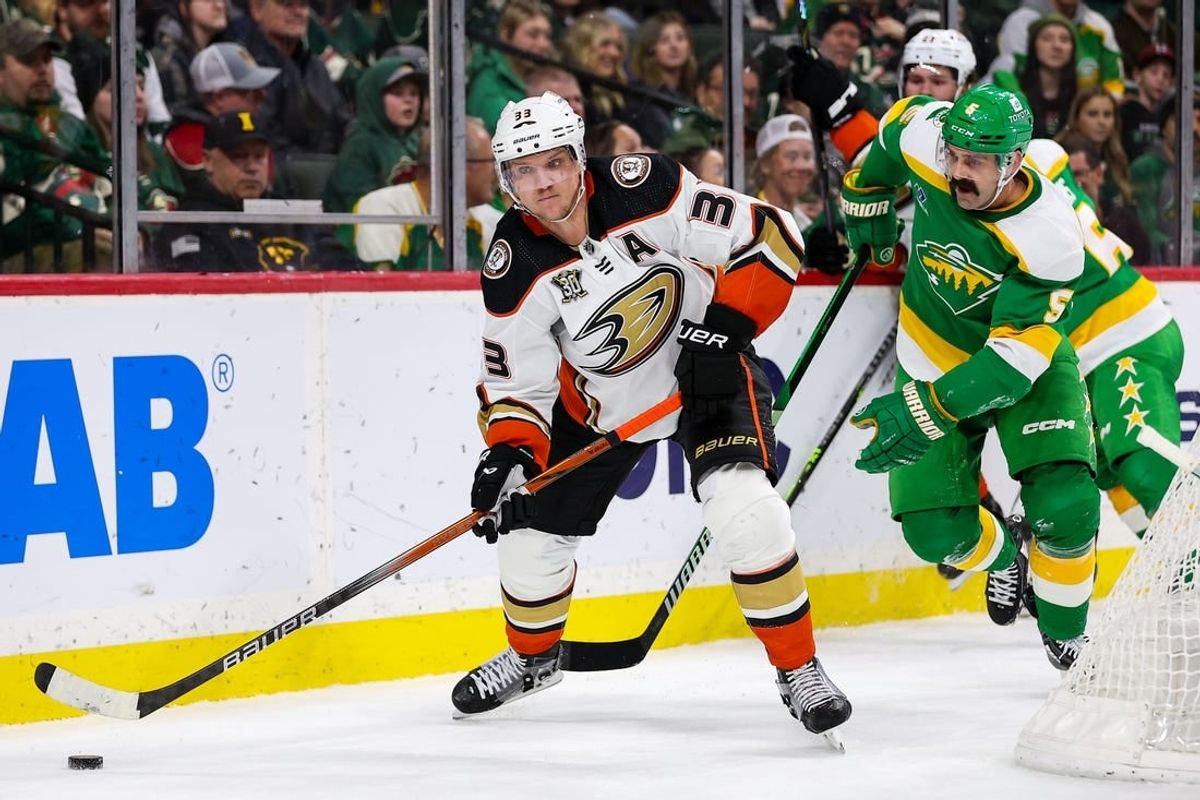 Jan 27, 2024; Saint Paul, Minnesota, USA; Anaheim Ducks right wing Jakob Silfverberg (33) passes as Minnesota Wild defenseman Jake Middleton (5) defends during the second period at Xcel Energy Center.