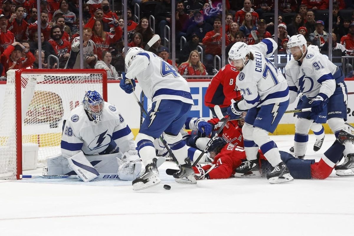 Dec 23, 2023; Washington, District of Columbia, USA; Washington Capitals center Dylan Strome (17) is checked from behind by Tampa Bay Lightning center Steven Stamkos (91) while reaching for the puck in front of Lightning goaltender Andrei Vasilevskiy (88) in the first period at Capital One Arena.
