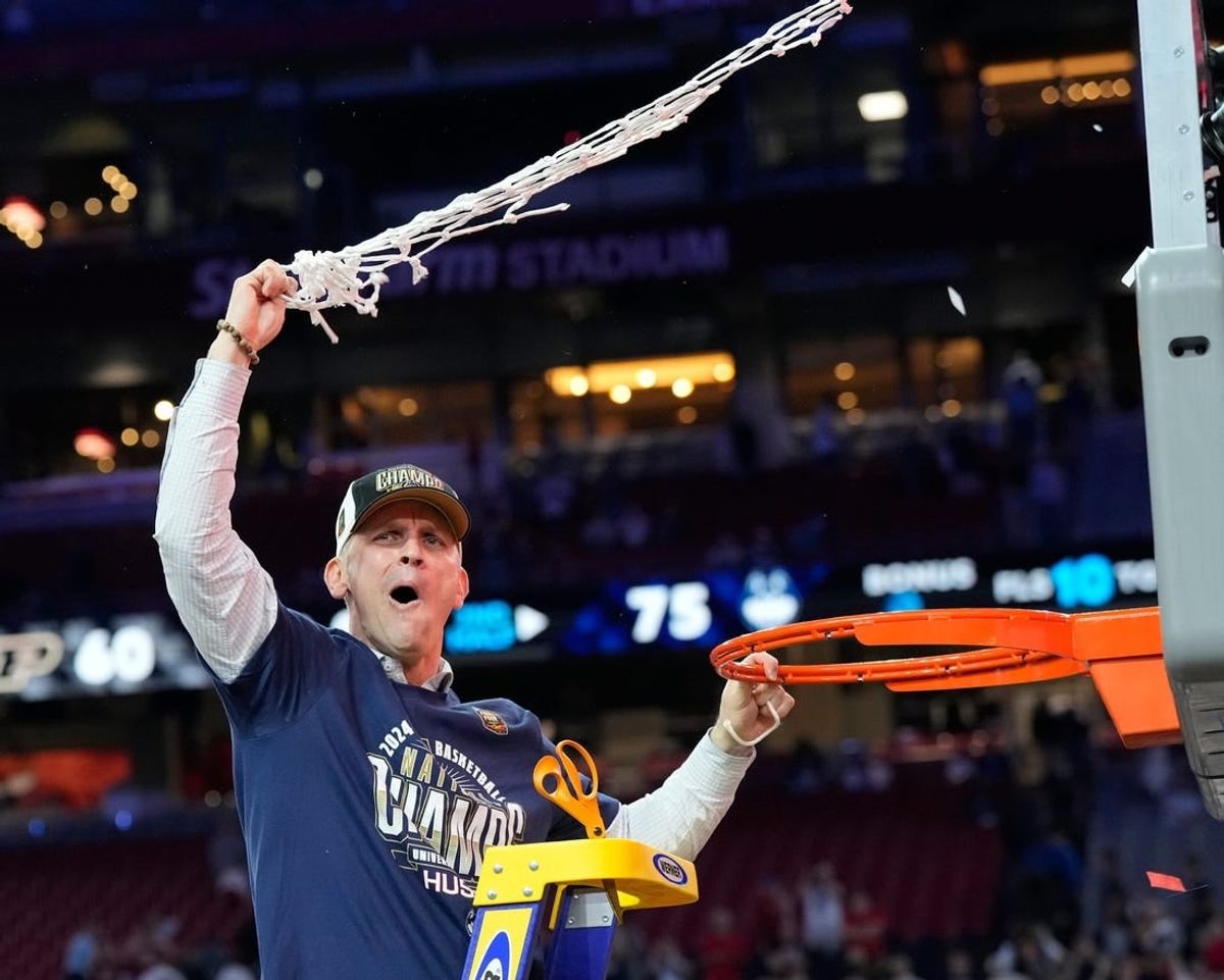 Connecticut Huskies head coach Dan Hurley cuts the basketball net winning the Men's NCAA national championship game against the Purdue Boilermakers at State Farm Stadium in Glendale on April 8, 2024.