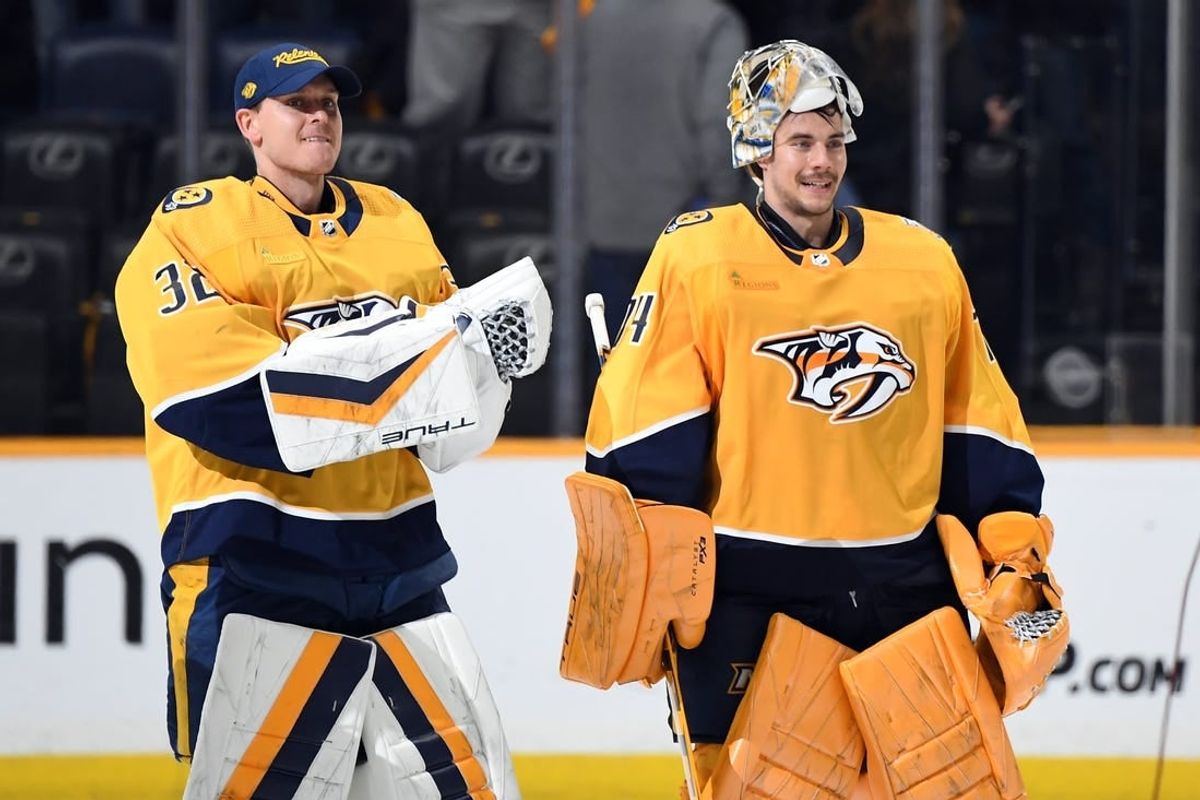 Mar 23, 2024; Nashville, Tennessee, USA; Nashville Predators goaltender Kevin Lankinen (32) and goaltender Juuse Saros (74) skate after a win against the Detroit Red Wings at Bridgestone Arena.