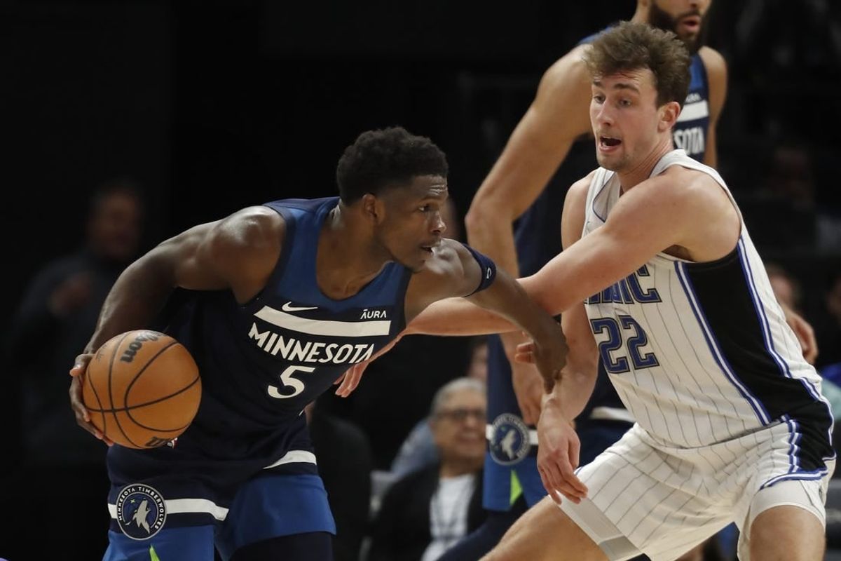 Feb 2, 2024; Minneapolis, Minnesota, USA; Minnesota Timberwolves guard Anthony Edwards (5) works around Orlando Magic forward Franz Wagner (22) in the fourth quarter at Target Center.