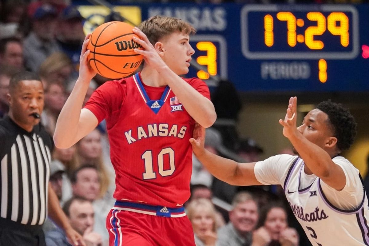 Mar 5, 2024; Lawrence, Kansas, USA; Kansas Jayhawks guard Johnny Furphy (10) looks to pass as Kansas State Wildcats guard Tylor Perry (2) defends during the first half at Allen Fieldhouse.