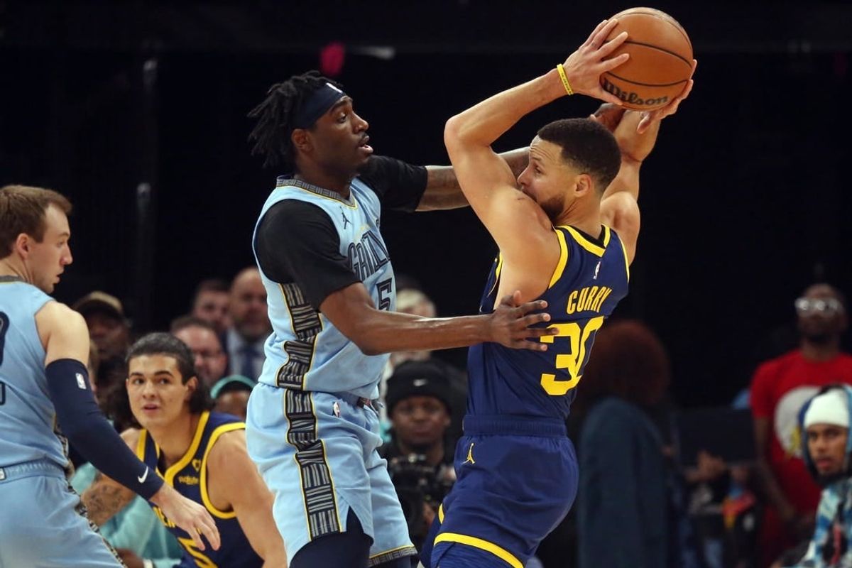 Feb 2, 2024; Memphis, Tennessee, USA; Golden State Warriors guard Stephen Curry (30) handles the ball as Memphis Grizzlies guard Vince Williams Jr. (5) defends during the first half at FedExForum.