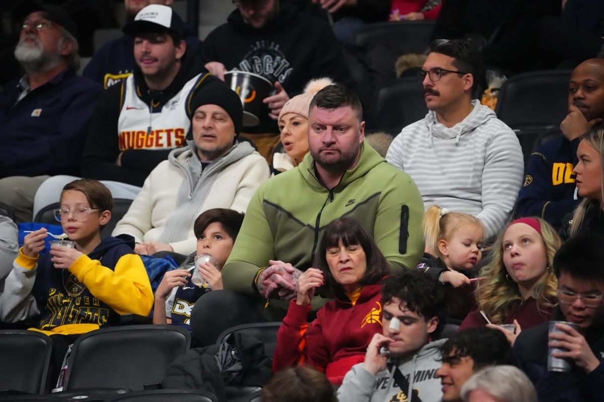 Jan 14, 2024; Denver, Colorado, USA; Strahinja Jokic (center) the brother of Denver Nuggets center Nikola Jokic (not pictured) watches the game against the Indiana Pacers at Ball Arena.