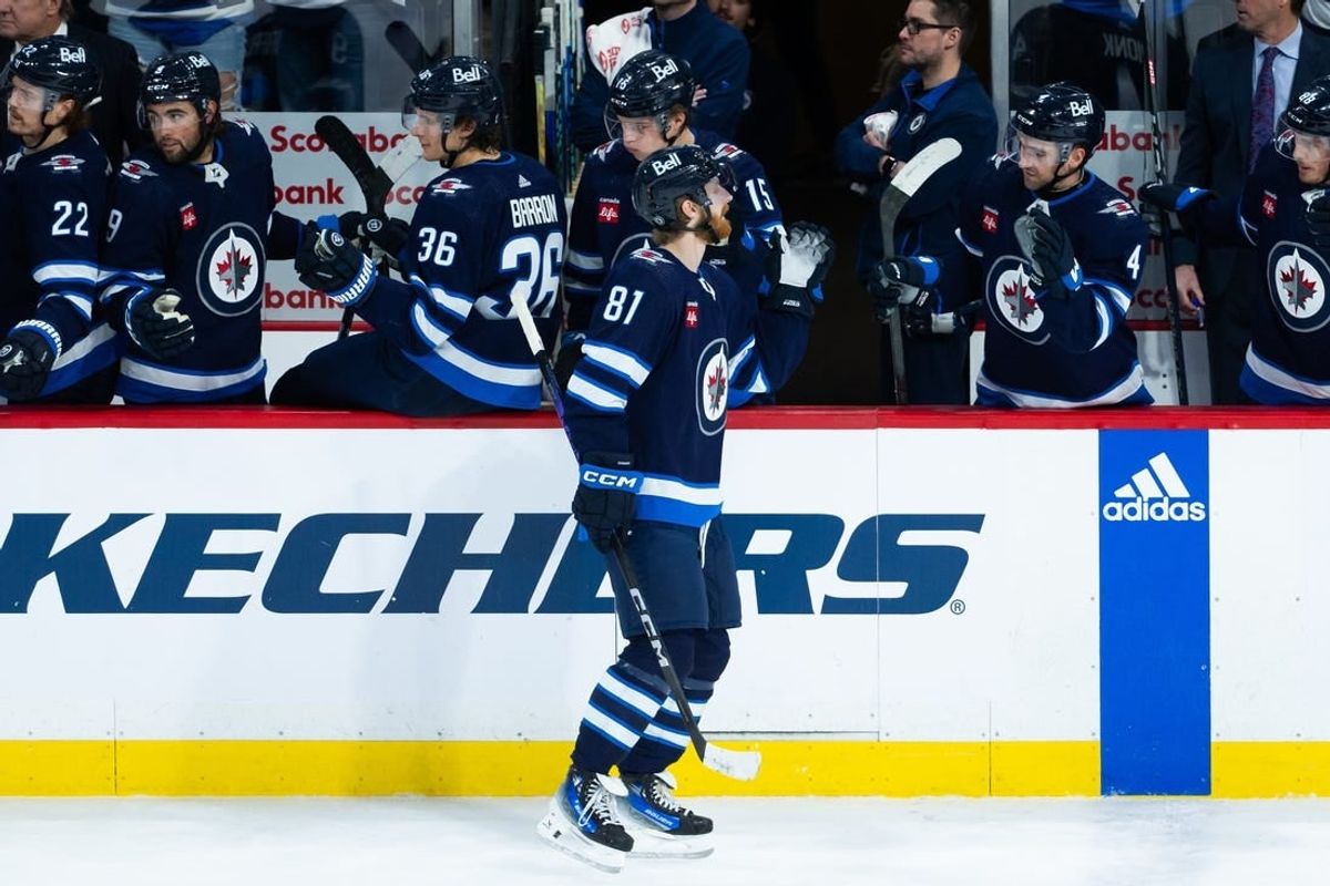 Jan 16, 2024; Winnipeg, Manitoba, CAN; Winnipeg Jets forward Kyle Connor (81) is congratulated by his teammates on his goal against the New York Islanders during the third period at Canada Life Centre.
