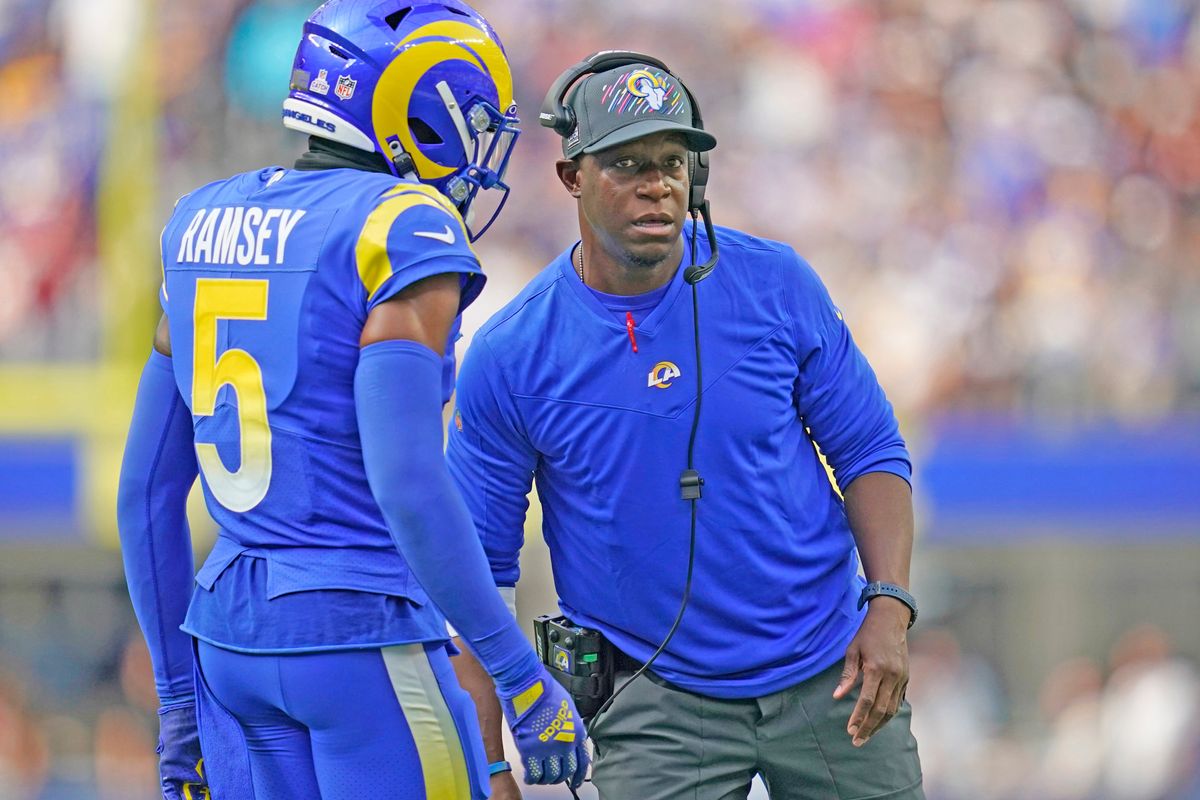 Raheem Morris talks with Jalen Ramsey during the season.