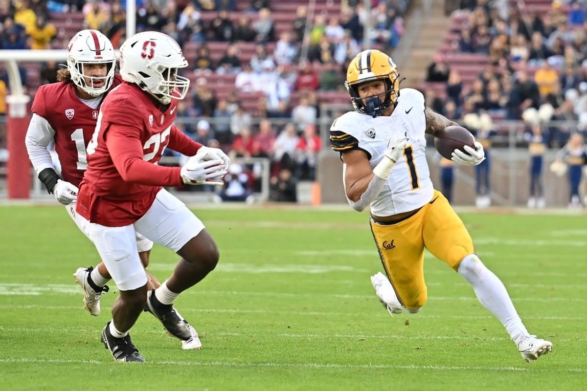Nov 18, 2023; Stanford, California, USA; California Golden Bears running back Jaydn Ott (1) runs with the football against Stanford Cardinal linebacker David Bailey (23) during the first quarter at Stanford Stadium.