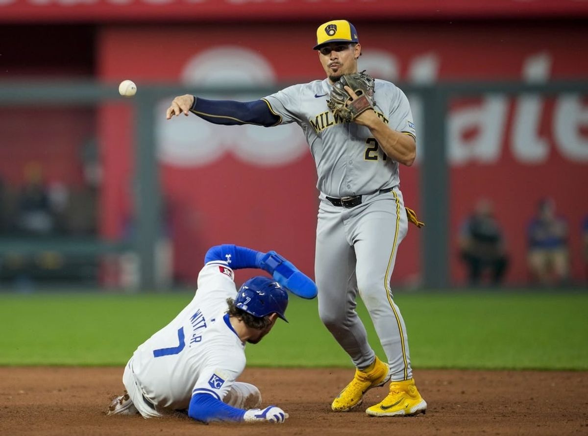May 6, 2024; Kansas City, Missouri, USA; Milwaukee Brewers shortstop Willy Adames (27) throws to first base after forcing out Kansas City Royals shortstop Bobby Witt Jr. (7) during the sixth inning at Kauffman Stadium.