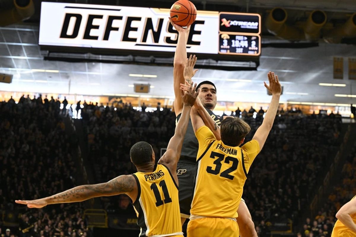 Jan 20, 2024; Iowa City, Iowa, USA; Purdue Boilermakers center Zach Edey (15) shoots the ball over Iowa Hawkeyes forward Owen Freeman (32) and guard Tony Perkins (11) during the first half at Carver-Hawkeye Arena.