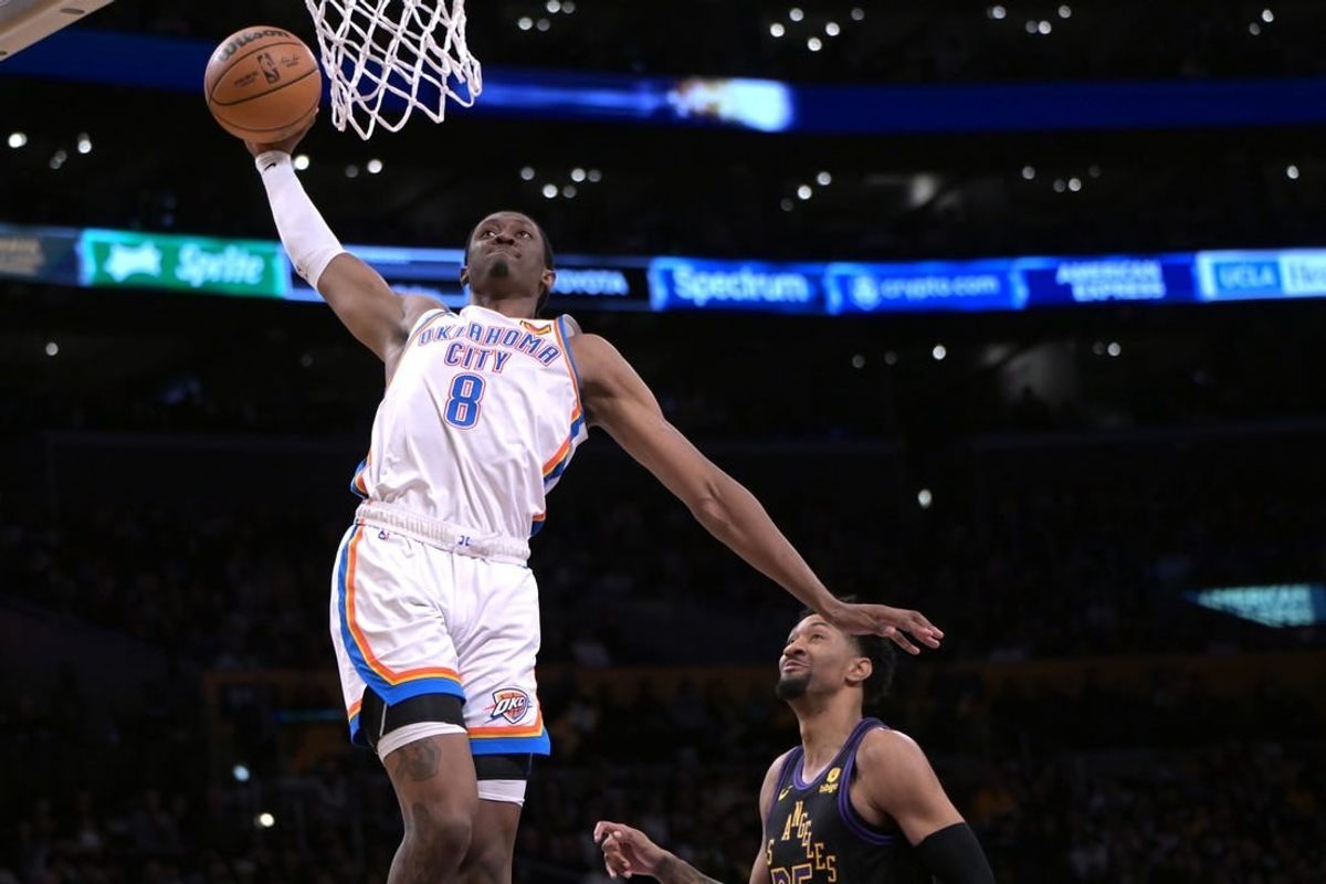 Jan 15, 2024; Los Angeles, California, USA; Oklahoma City Thunder forward Jalen Williams (8) scores past Los Angeles Lakers forward Christian Wood (35) in the second half against at Crypto.com Arena.