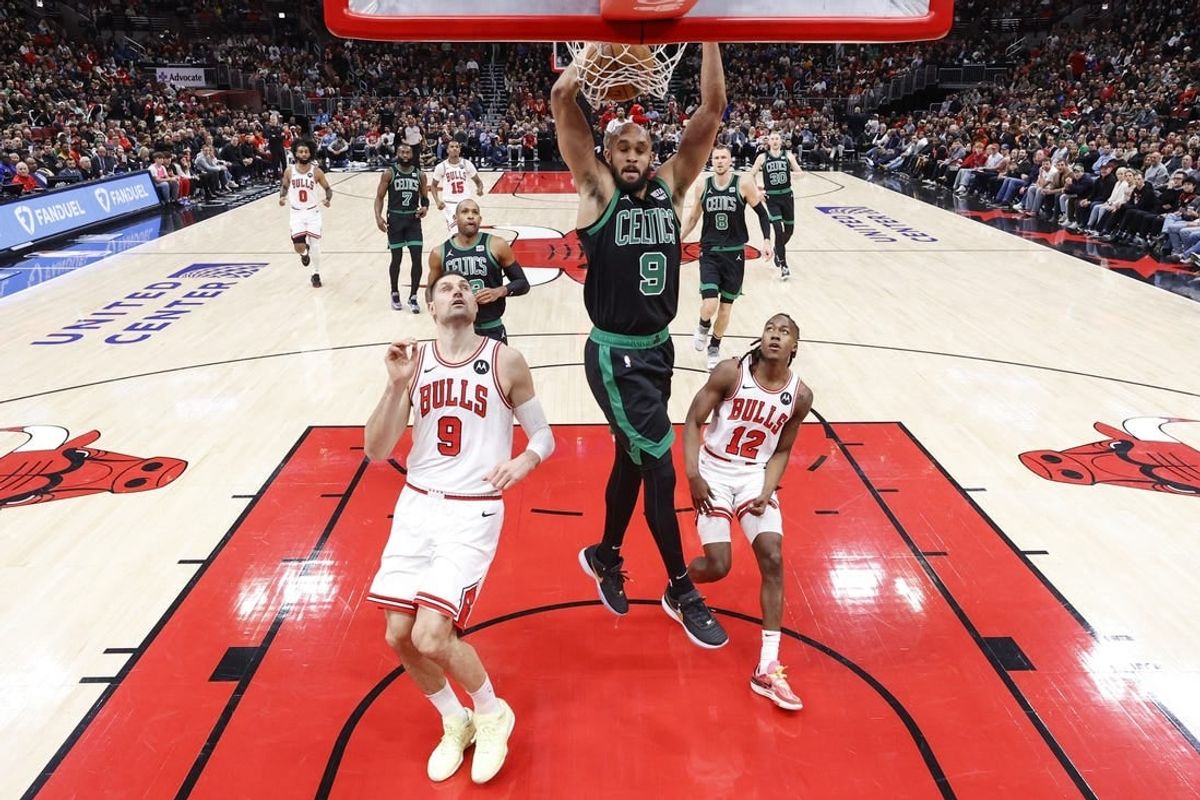 Feb 22, 2024; Chicago, Illinois, USA; Boston Celtics guard Derrick White (9) dunks the ball against the Chicago Bulls during the first half at United Center.
