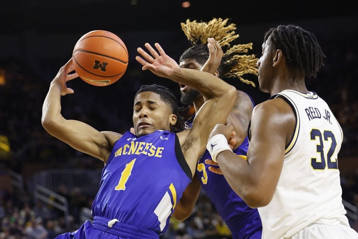 Dec 29, 2023; Ann Arbor, Michigan, USA;  m1 go for the rebound in the first half over Michigan Wolverines forward Tarris Reed Jr. (32) in the first half at Crisler Center.