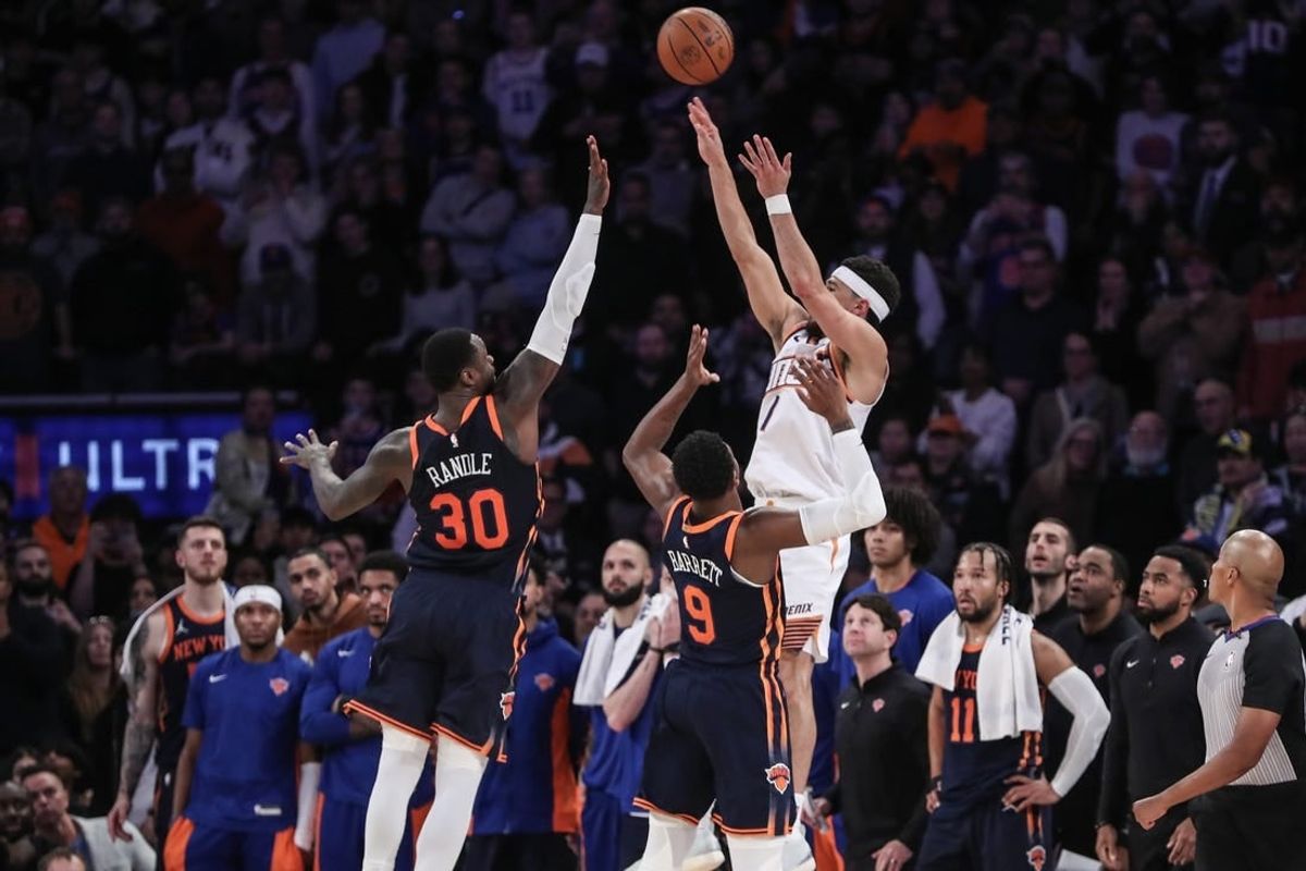 Nov 26, 2023; New York, New York, USA; Phoenix Suns guard Devin Booker (1) takes the game winning three-point shot in the fourth quarter against the New York Knicks at Madison Square Garden.