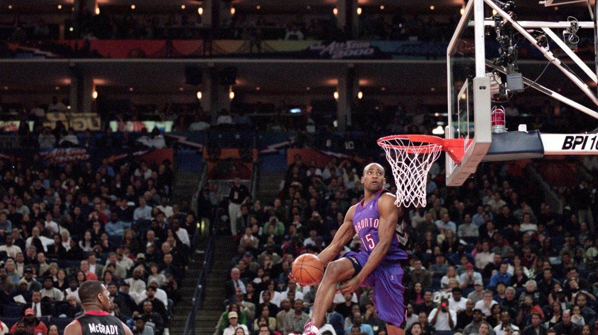 Vince Carter of the Toronto Raptors jumps to dunk the ball during the NBA All-Star Weekend Slam Dunk Contest at the Oakland Coliseum in Oakland, California in February 2000.