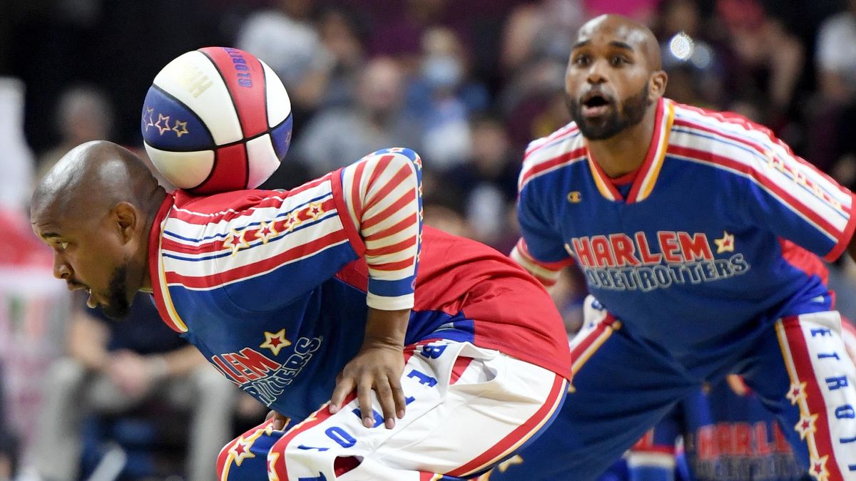 Shane “Scooter” Christensen of the Harlem Globetrotters handles the ball in the Magic Circle as his teammate Carlos “Dizzy” English looks on.