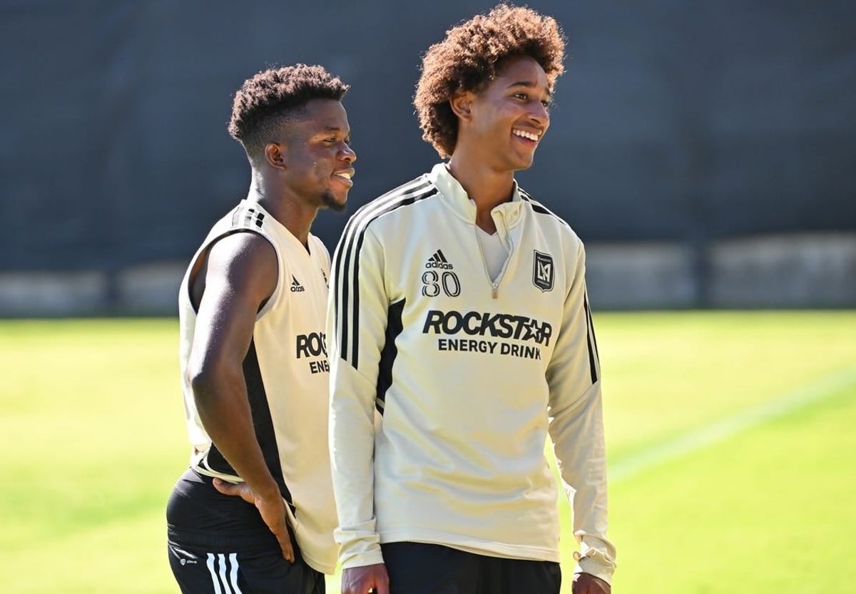 Nov 2, 2022; Los Angeles, California, US;  LAFC forward Kwadwo Opokug (22) and defender Julian Gaines (80) laugh during practice at the Nectar Performance Center.