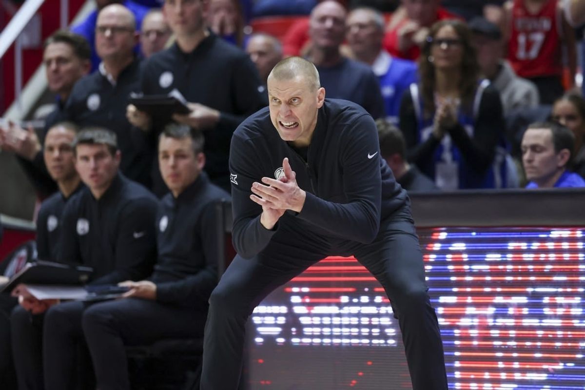 Dec 9, 2023; Salt Lake City, Utah, USA; Brigham Young Cougars head coach Mark Pope encourages the team against the Utah Utes during the second half at Jon M. Huntsman Center.
