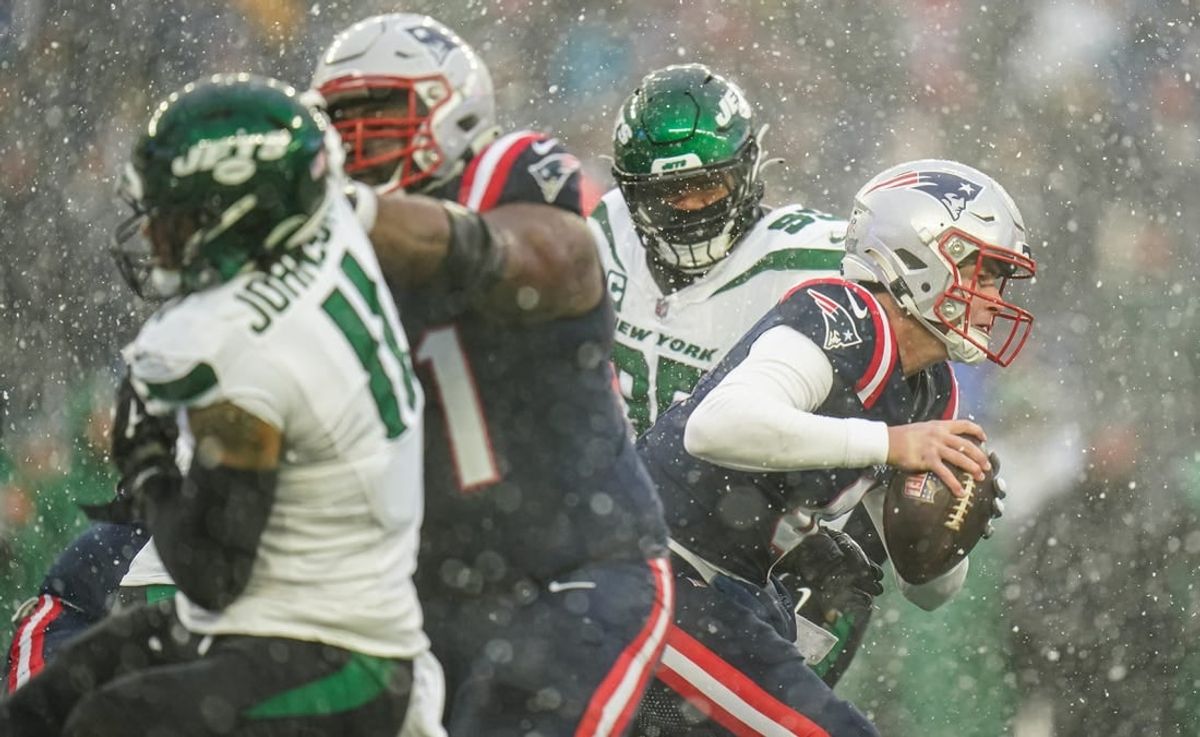 Jan 7, 2024; Foxborough, Massachusetts, USA; New England Patriots quarterback Bailey Zappe (4) under pressure from the New York Jets in the second quarter at Gillette Stadium.