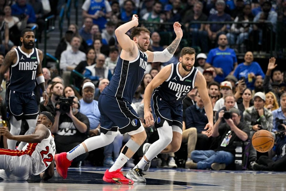 Mar 7, 2024; Dallas, Texas, USA; Dallas Mavericks guard Luka Doncic (77) and forward Maxi Kleber (42) chase the loose ball during the second half against the Miami Heat at the American Airlines Center.