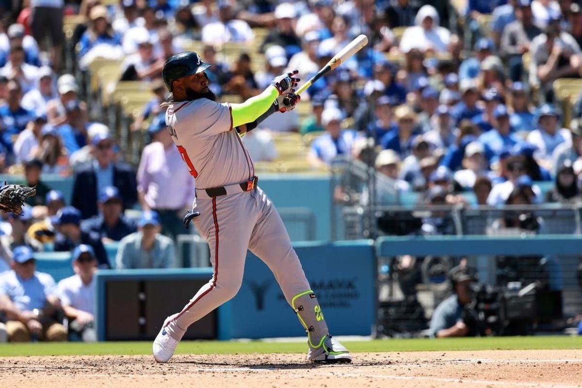 May 5, 2024; Los Angeles, California, USA;  Atlanta Braves designated hitter Marcell Ozuna (20) hits a home run during the seventh inning against the Los Angeles Dodgers at Dodger Stadium.