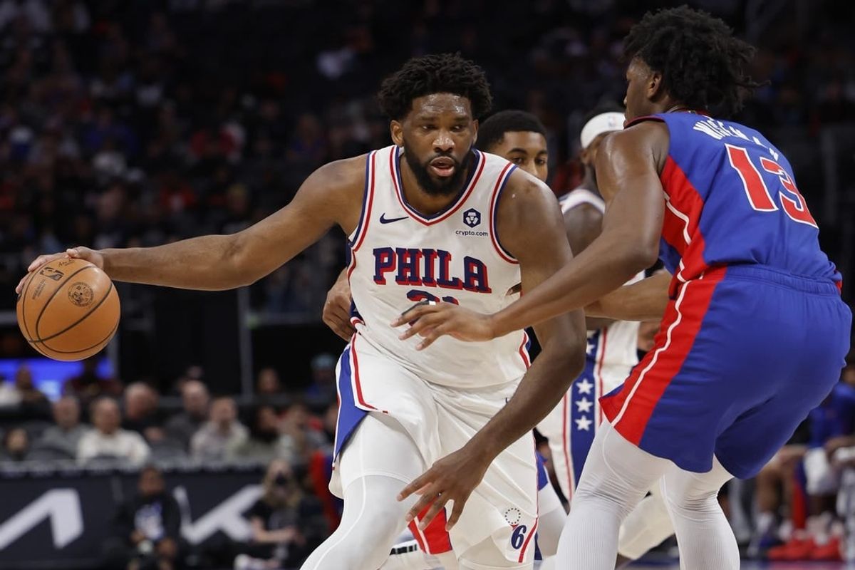 Dec 13, 2023; Detroit, Michigan, USA;  Philadelphia 76ers center Joel Embiid (21) is defended by Detroit Pistons center James Wiseman (13) in the first half at Little Caesars Arena.