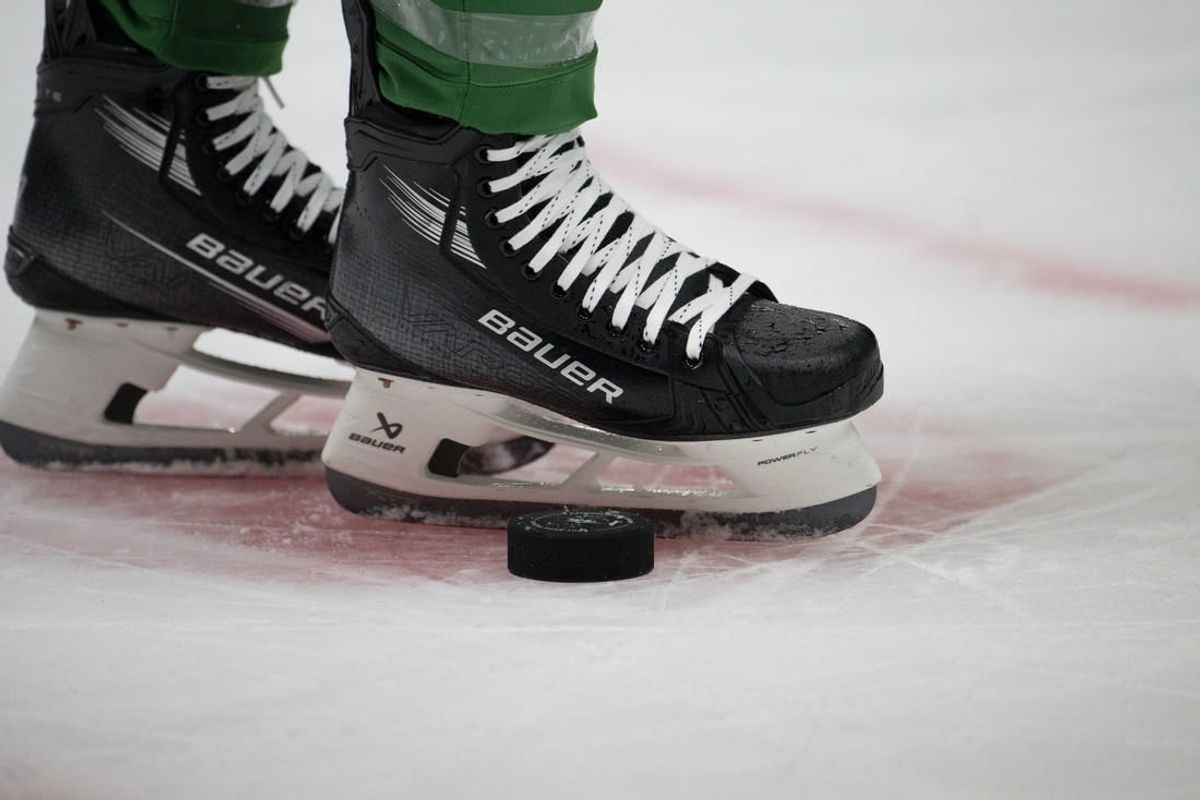 Oct 5, 2023; Dallas, Texas, USA; A view of the game puck and the face-off circle and hockey skates during the game between the Dallas Stars and the St. Louis Blues at the American Airlines Center.