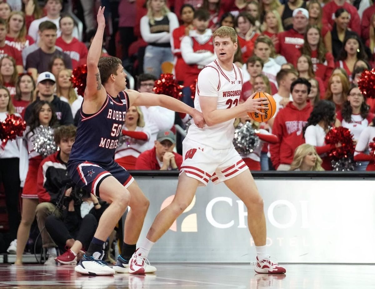 Nov 17, 2023; Madison, Wisconsin, USA; Wisconsin Badgers forward Steven Crowl (22) looks to the basket under coverage by Robert Morris Colonials forward Trey James (50) during the first half at the Kohl Center.