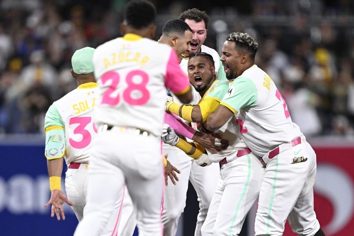 May 10, 2024; San Diego, California, USA; San Diego Padres designated hitter Luis Arraez (4) celebrates with teammates after hitting a walk-off single against the Los Angeles Dodgers at Petco Park.
