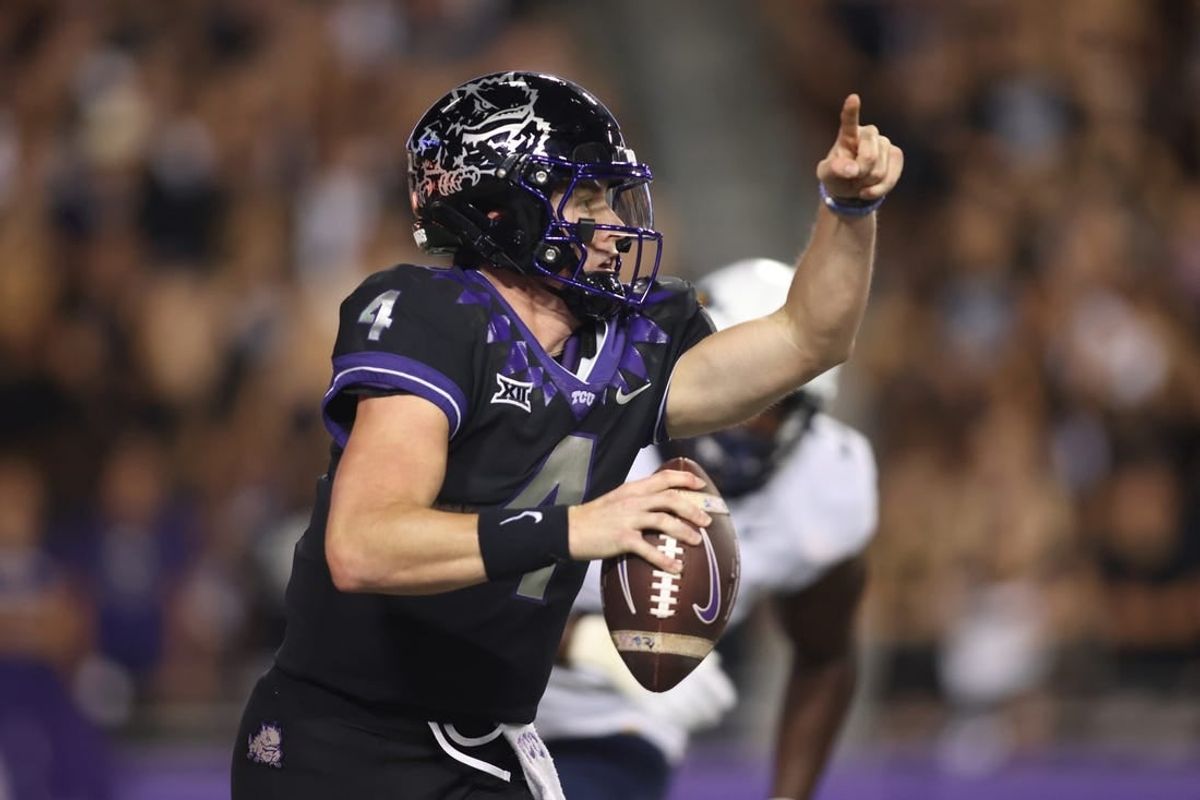 Sep 30, 2023; Fort Worth, Texas, USA; TCU Horned Frogs quarterback Chandler Morris (4) rolls out to pass against West Virginia Mountaineers defensive lineman Tomiwa Durojaiye (3) in the second quarter at Amon G. Carter Stadium.