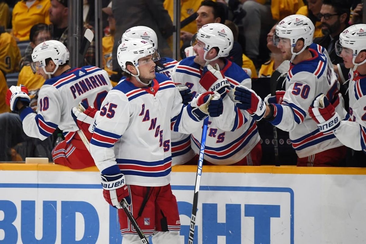 Dec 2, 2023; Nashville, Tennessee, USA; New York Rangers defenseman Ryan Lindgren (55) is congratulated by teammates after a goal during the third period against the Nashville Predators at Bridgestone Arena.