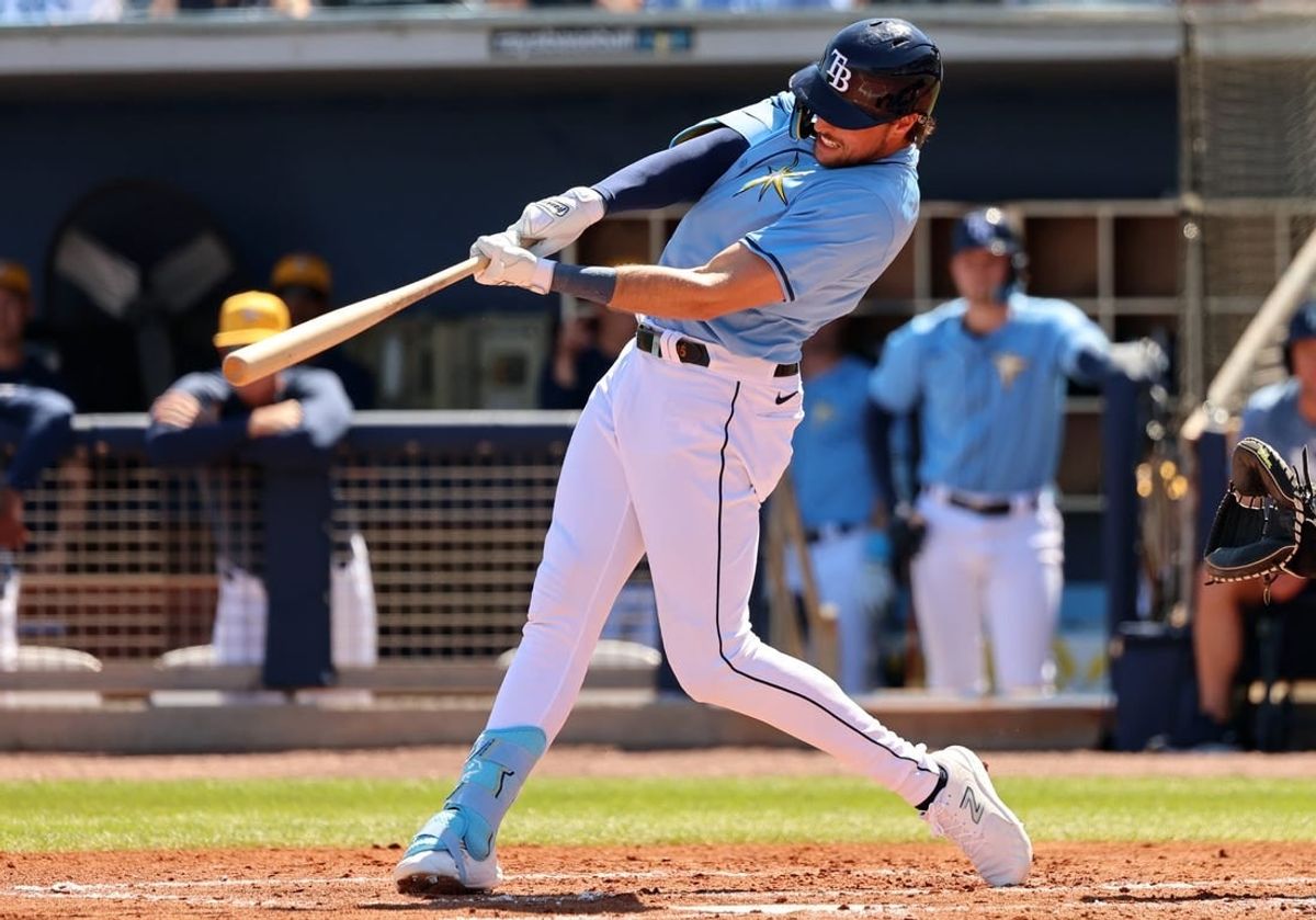 Feb 27, 2024; Port Charlotte, Florida, USA;  Tampa Bay Rays right fielder Josh Lowe (15) doubles during the second inning against the New York Yankees at Charlotte Sports Park.
