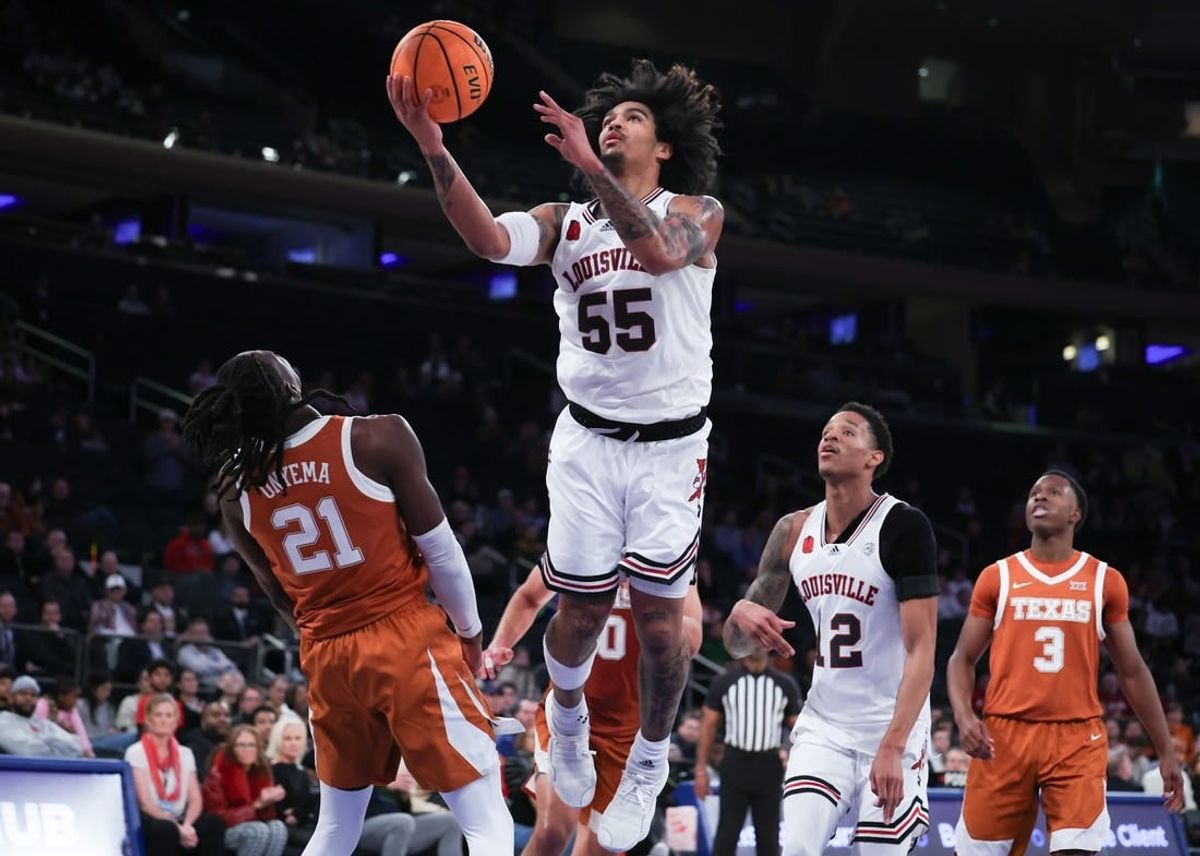 Nov 19, 2023; New York, New York, USA; Louisville Cardinals guard Skyy Clark (55) goes to the basket against Texas Longhorns forward Ze'Rik Onyema (21) during the second half at Madison Square Garden.