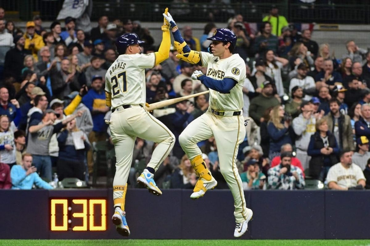 Apr 5, 2024; Milwaukee, Wisconsin, USA; Milwaukee Brewers left fielder Christian Yelich (22) celebrates with shortstop Willy Adames (27) after hitting a solo home run in the sixth inning against the Seattle Mariners  at American Family Field.