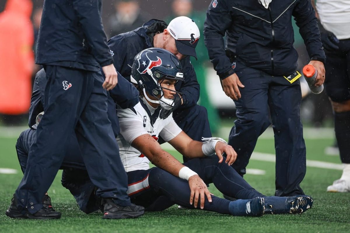 Dec 10, 2023; East Rutherford, New Jersey, USA; Houston Texans quarterback C.J. Stroud (7) with medical staff after suffering an apparent injury during the second half against the New York Jets at MetLife Stadium.