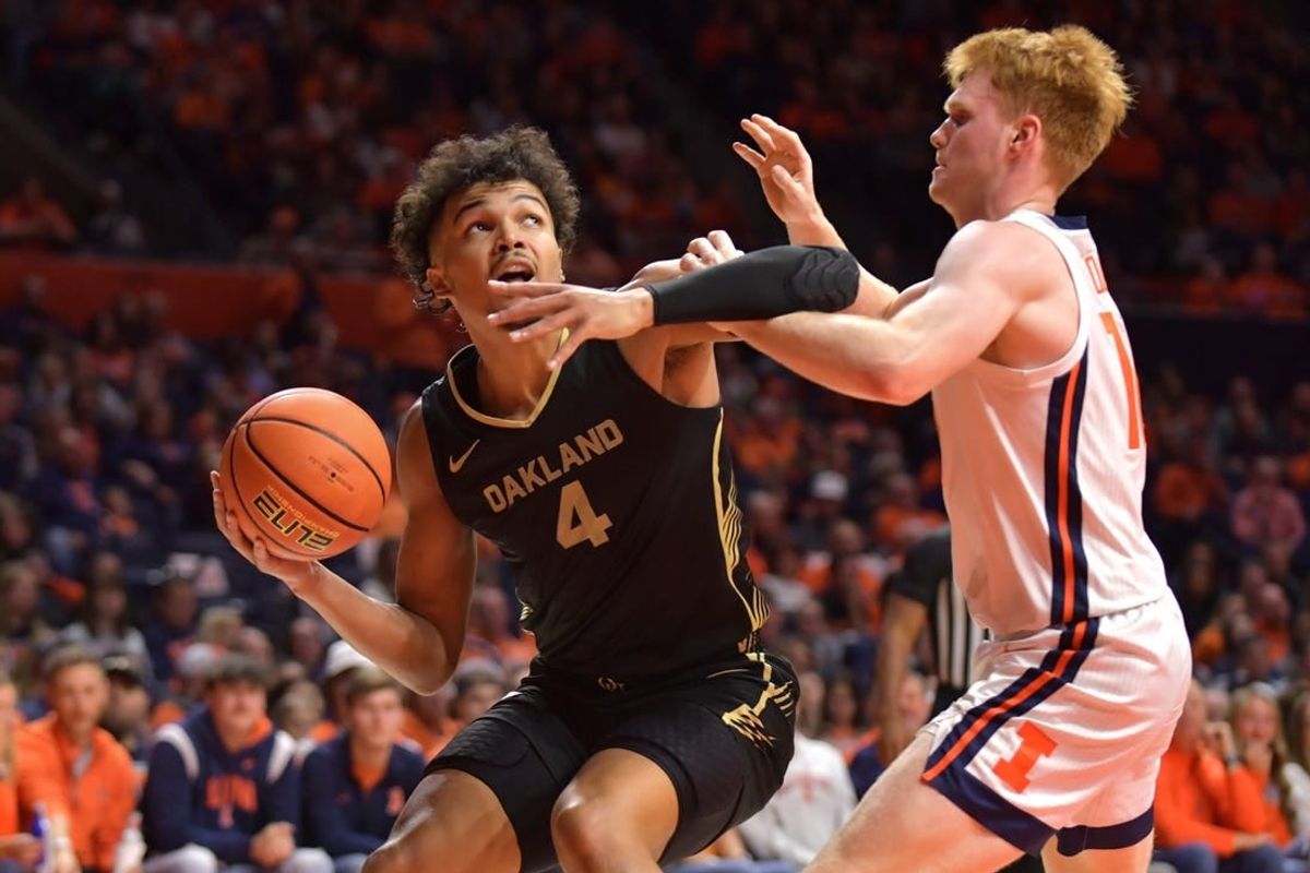 Nov 10, 2023; Champaign, Illinois, USA;  Oakland Golden Grizzlies forward Trey Townsend (4) looks to the basket as Illinois Fighting Illini guard Luke Goode (10) defends during the second half at State Farm Center.
