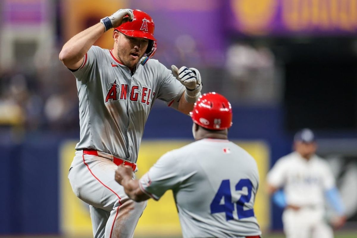 Apr 15, 2024; St. Petersburg, Florida, USA;  Los Angeles Angels outfielder Mike Trout (42) celebrates with  third base coach Eric Young Sr. (42) after hitting a two run home run against the Tampa Bay Rays in the eighth inning during Jackie Robinson day at Tropicana Field.