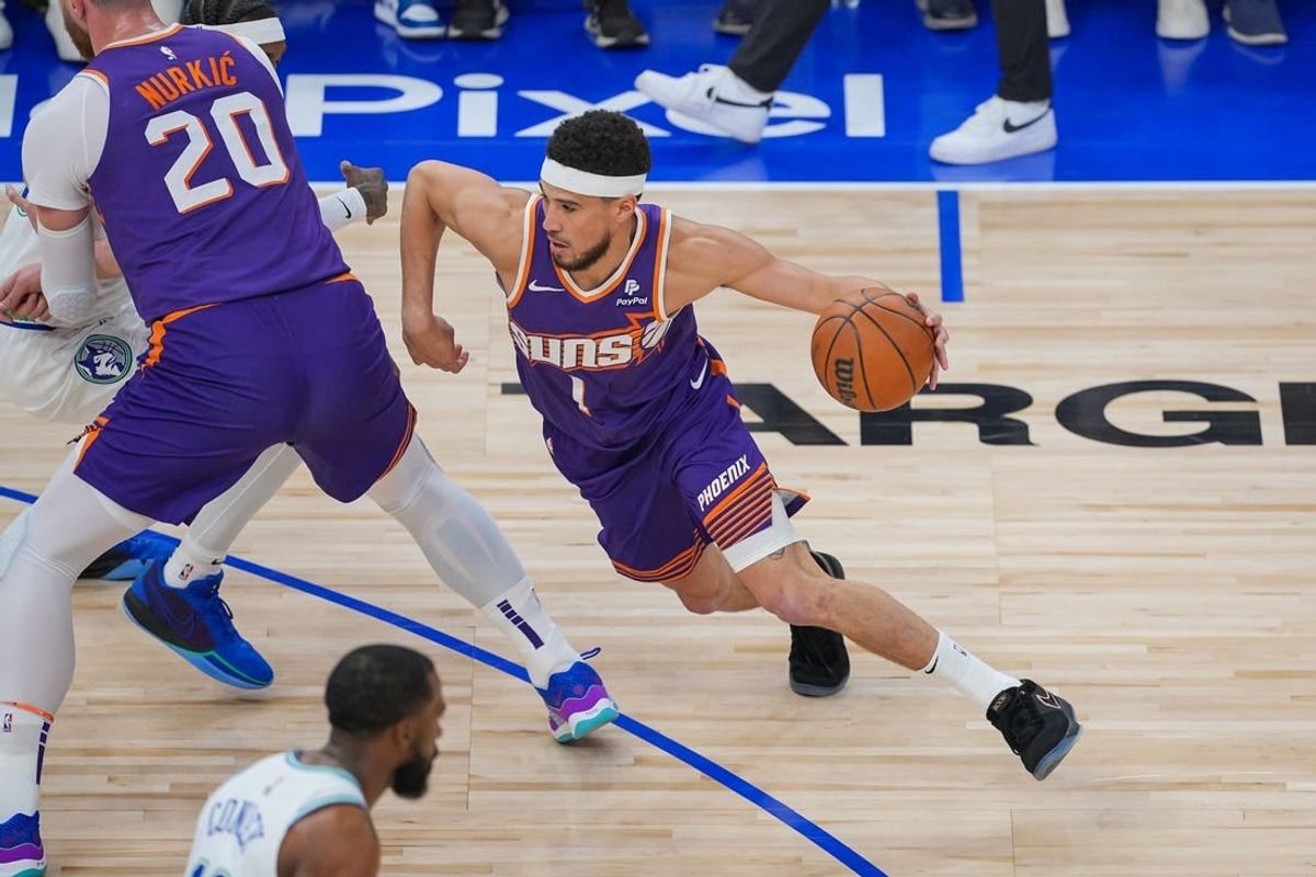 Apr 23, 2024; Minneapolis, Minnesota, USA; Phoenix Suns guard Devin Booker (1) dribbles against the Minnesota Timberwolves in the first quarter during game two of the first round for the 2024 NBA playoffs at Target Center.