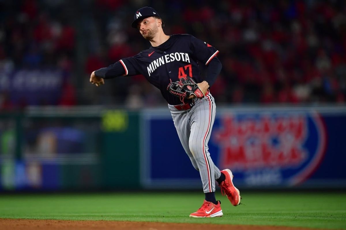Apr 27, 2024; Anaheim, California, USA; Minnesota Twins second baseman Edouard Julien (47) throws to first for the out against Los Angeles Angels right fielder Jo Adell (7) during the sixth inning at Angel Stadium.