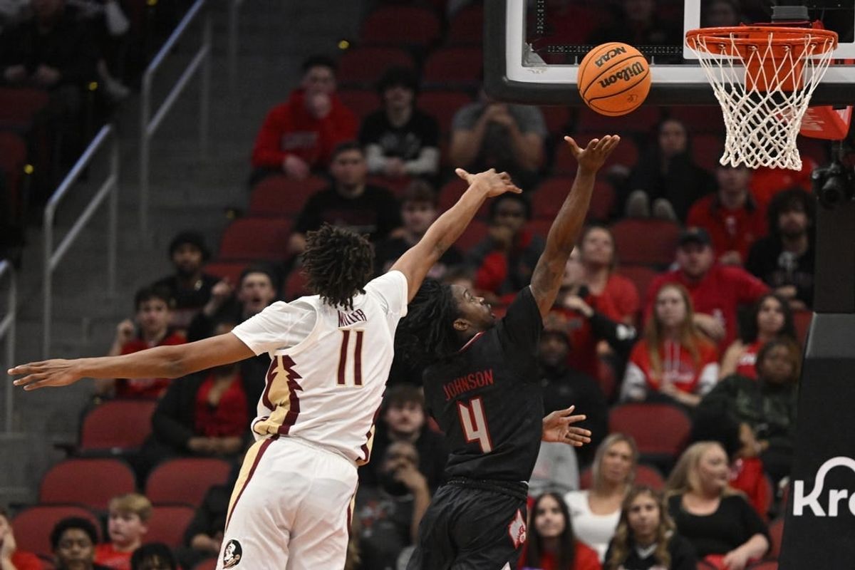 Feb 3, 2024; Louisville, Kentucky, USA; Louisville Cardinals guard Ty-Laur Johnson (4) shoots against Florida State Seminoles forward Baba Miller (11) during the first half at KFC Yum! Center.