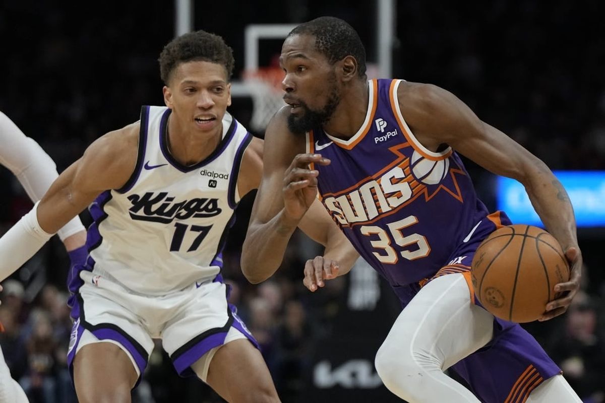 Feb 13, 2024; Phoenix, Arizona, USA; Phoenix Suns forward Kevin Durant (35) drives on Sacramento Kings forward Kessler Edwards (17)  in the first half at Footprint Center.
