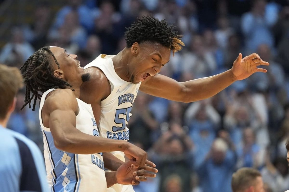 Feb 17, 2024; Chapel Hill, North Carolina, USA; North Carolina Tar Heels forward Harrison Ingram (55) and forward Jae'Lyn Withers (24) celebrate in the first half at Dean E. Smith Center.