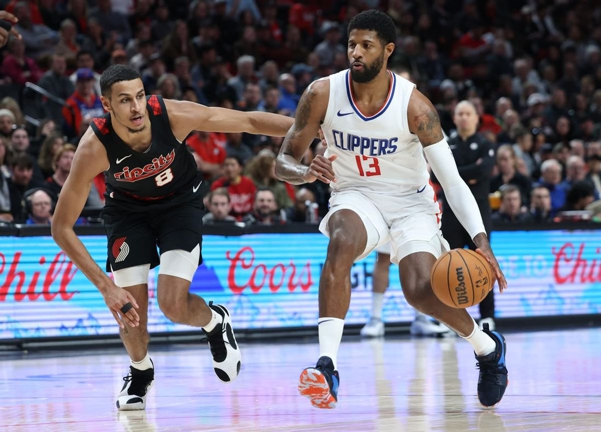 Mar 20, 2024; Portland, Oregon, USA; LA Clippers forward Paul George (13) dribbles past Portland Trail Blazers forward Kris Murray (8) in the second quarter at Moda Center.