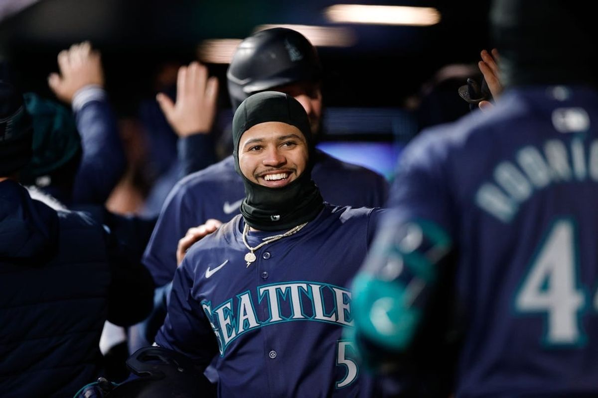 Apr 20, 2024; Denver, Colorado, USA; Seattle Mariners left fielder Jonatan Clase (5) reacts in the dugout after a play in the fifth inning against the Colorado Rockies at Coors Field.