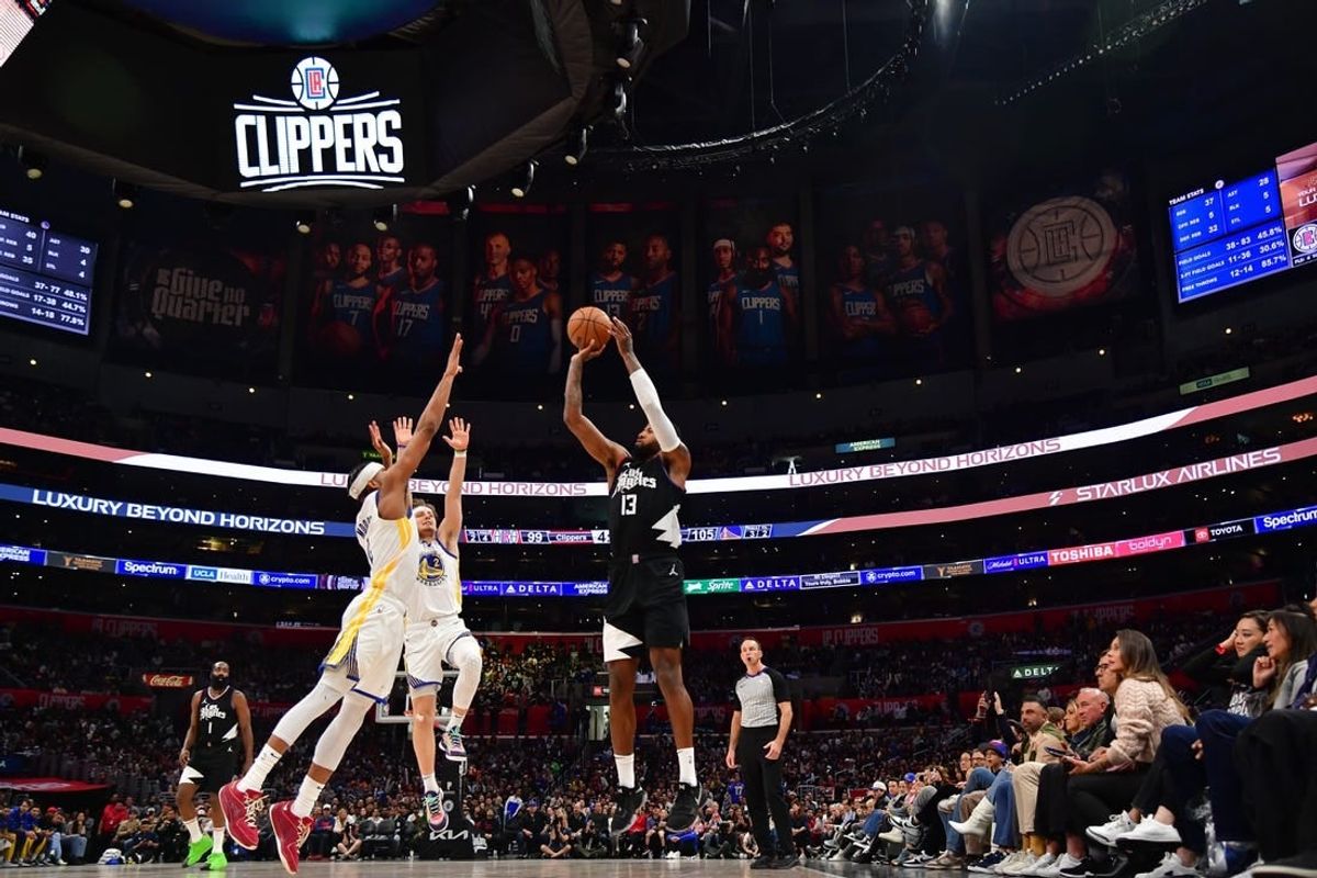 Dec 2, 2023; Los Angeles, California, USA; Los Angeles Clippers forward Paul George (13) shoots against Golden State Warriors guard Moses Moody (4) during the second half at Crypto.com Arena.