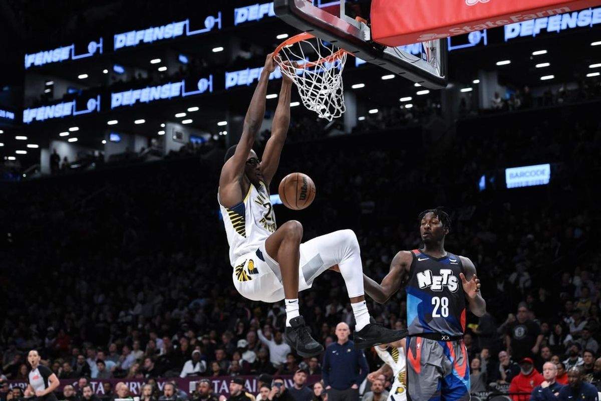 Apr 3, 2024; Brooklyn, New York, USA; Indiana Pacers forward Jalen Smith (25) dunks the ball as Brooklyn Nets forward Dorian Finney-Smith (28) looks on during the second quarter at Barclays Center.