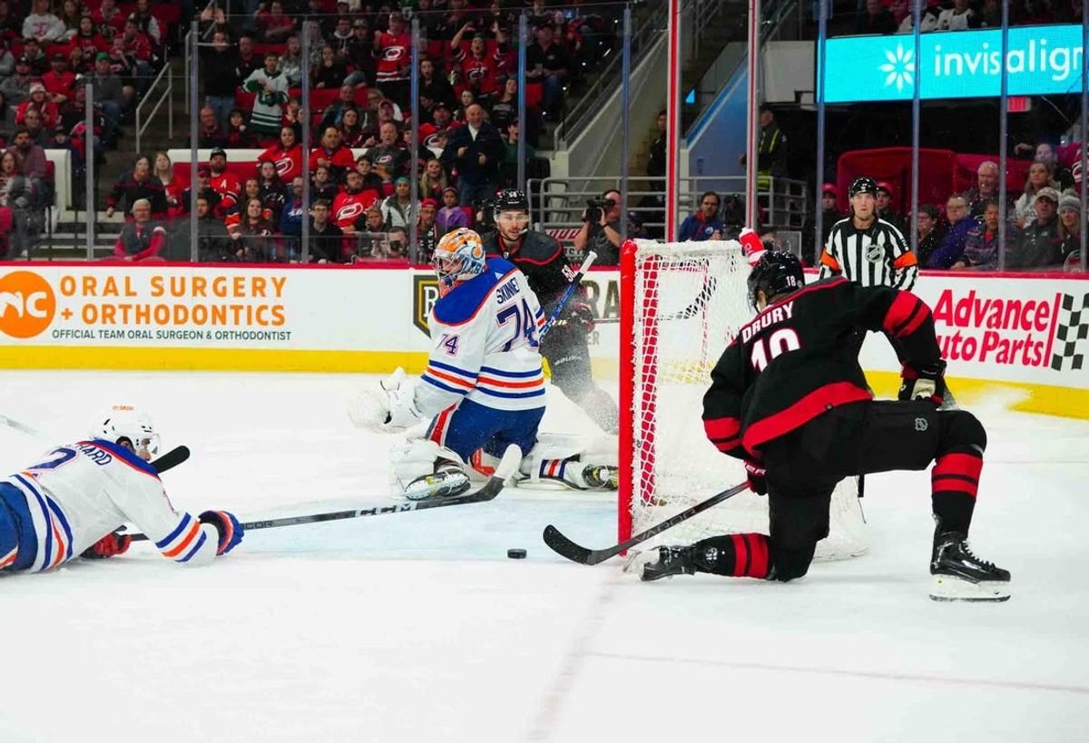 Nov 22, 2023; Raleigh, North Carolina, USA; Carolina Hurricanes center Jack Drury (18) scores a goal past Edmonton Oilers goaltender Stuart Skinner (74) during the first period at PNC Arena.