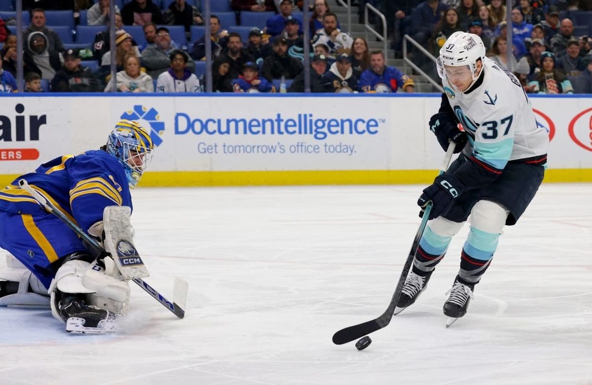 Jan 9, 2024; Buffalo, New York, USA;  Seattle Kraken center Yanni Gourde (37) looks to take a shot on Buffalo Sabres goaltender Devon Levi (27) during the third period at KeyBank Center.