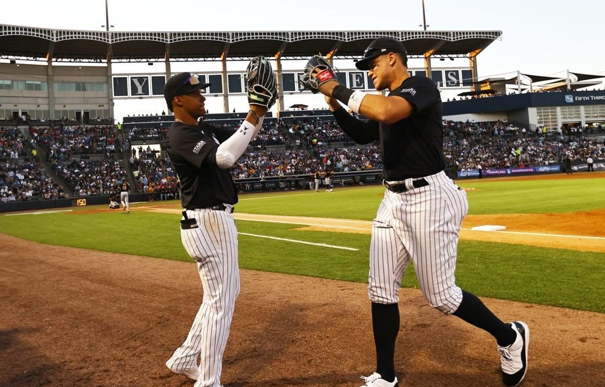 Mar 20, 2024; Tampa, Florida, USA; New York Yankees left fielder Juan Soto (22) and right fielder Aaron Judge (99) high five against the Pittsburgh Pirates at George M. Steinbrenner Field.
